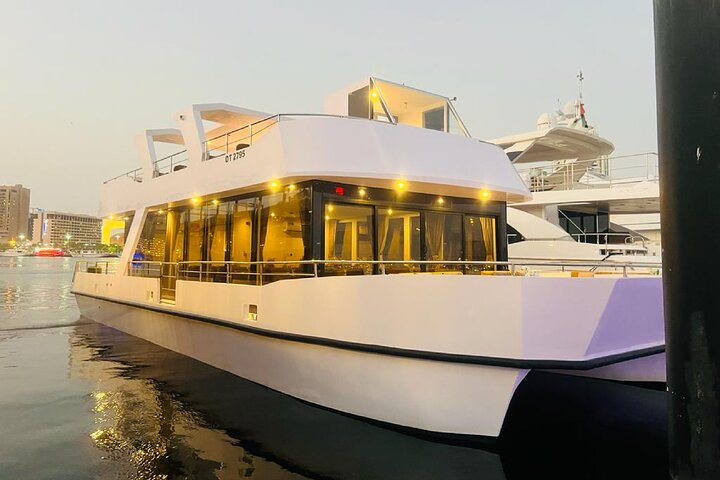 Experience stunning views of Dubai's skyline aboard a stylish catamaran where live entertainment and a delicious international buffet dinner await as you glide across the serene waters.